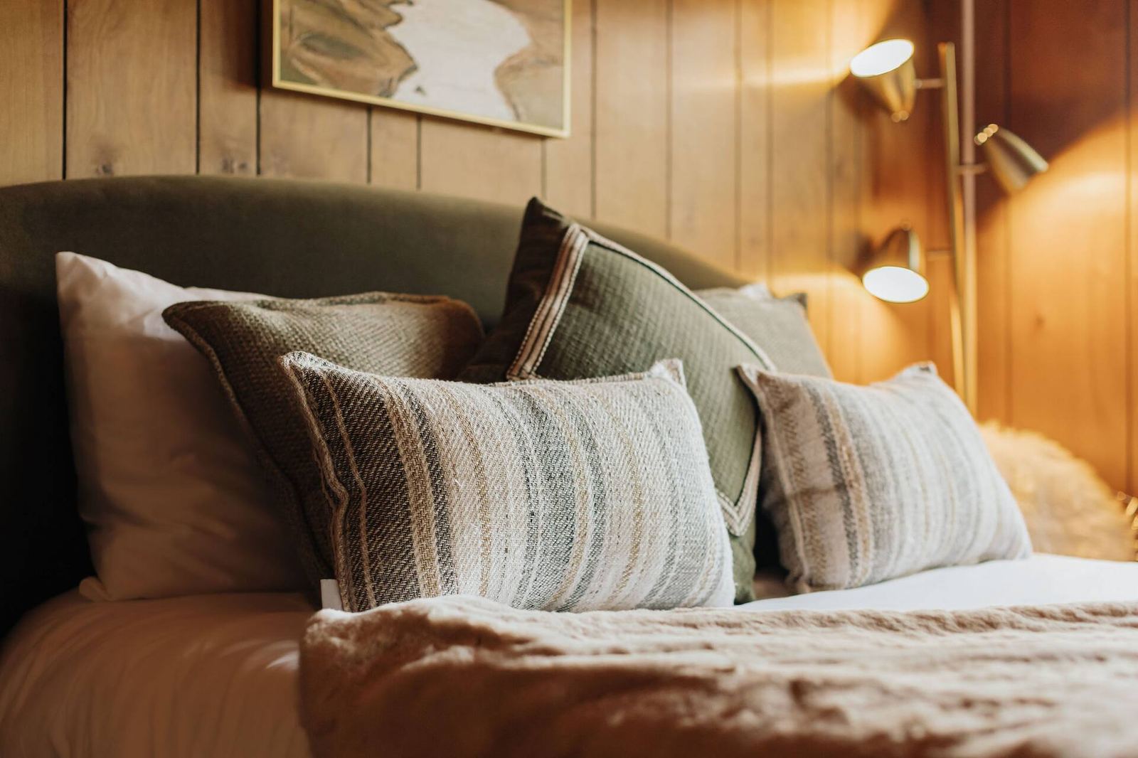 Queen bed pillow detail with reading lamp