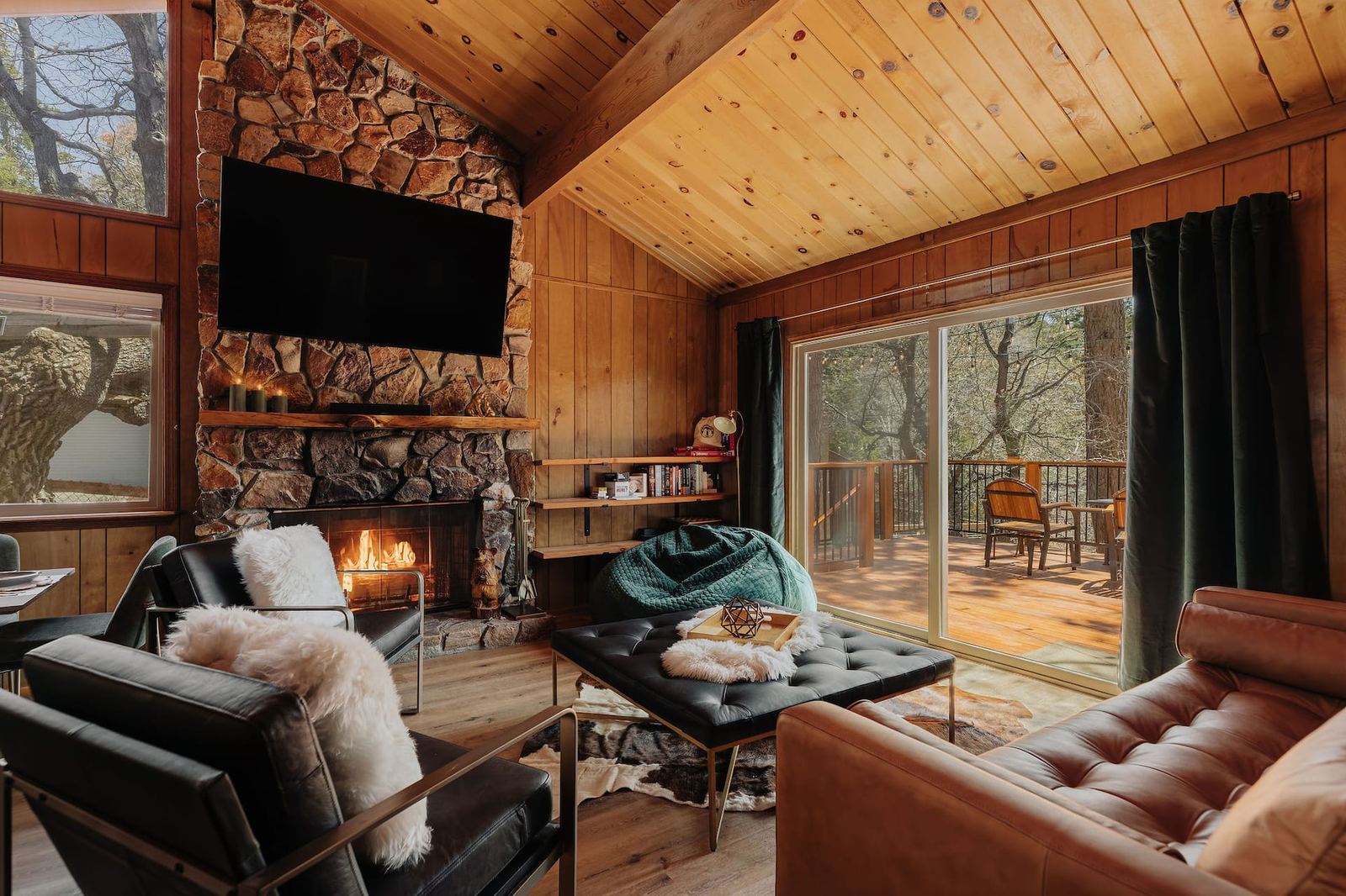 Rock fireplace faced with stone native to Big Bear, with a sliding door to the deck