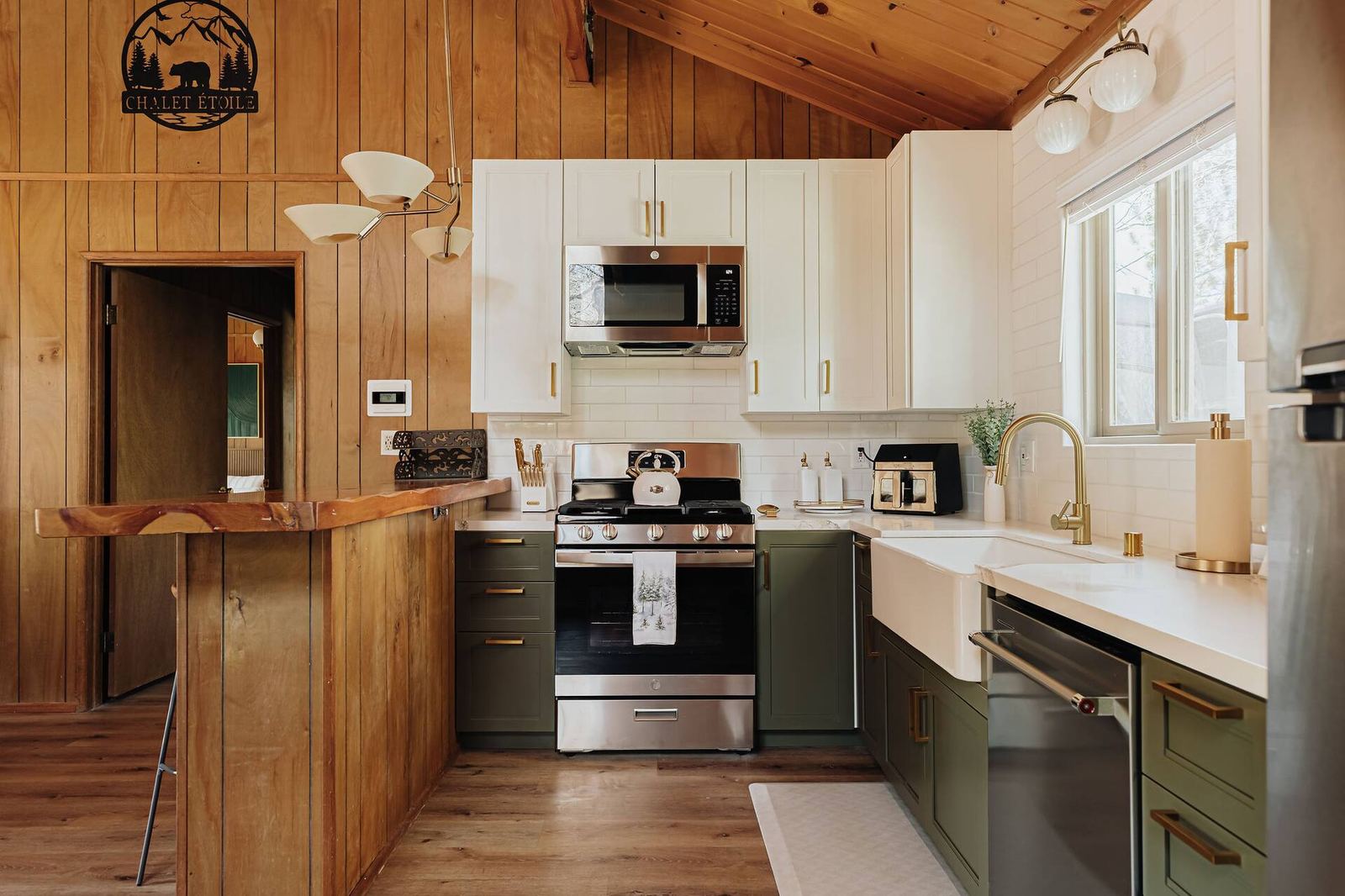 The remodeled kitchen with the farmhouse sink and gas range